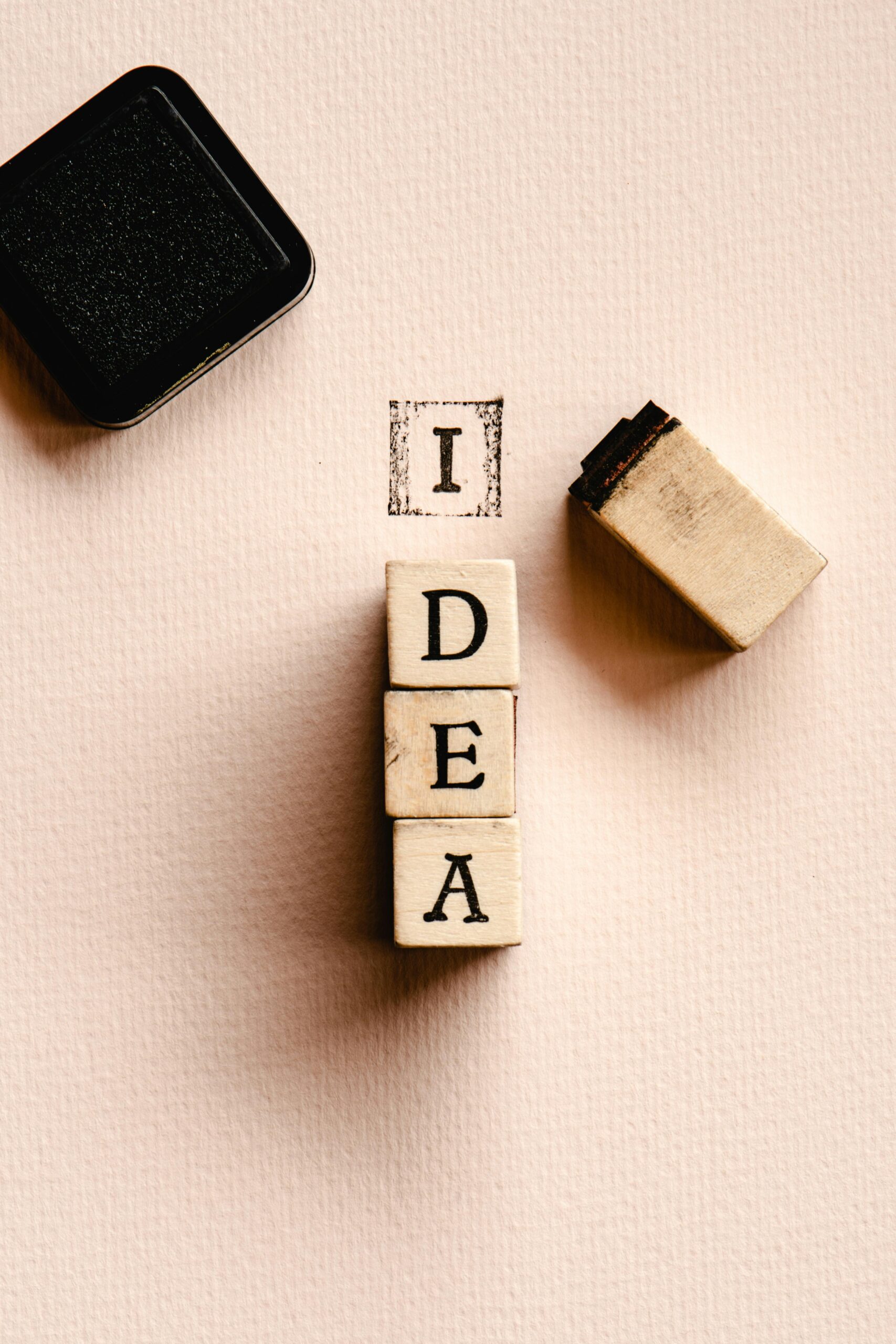 Close-up of letter stamps forming the word 'IDEA', inspiring creativity and knowledge.